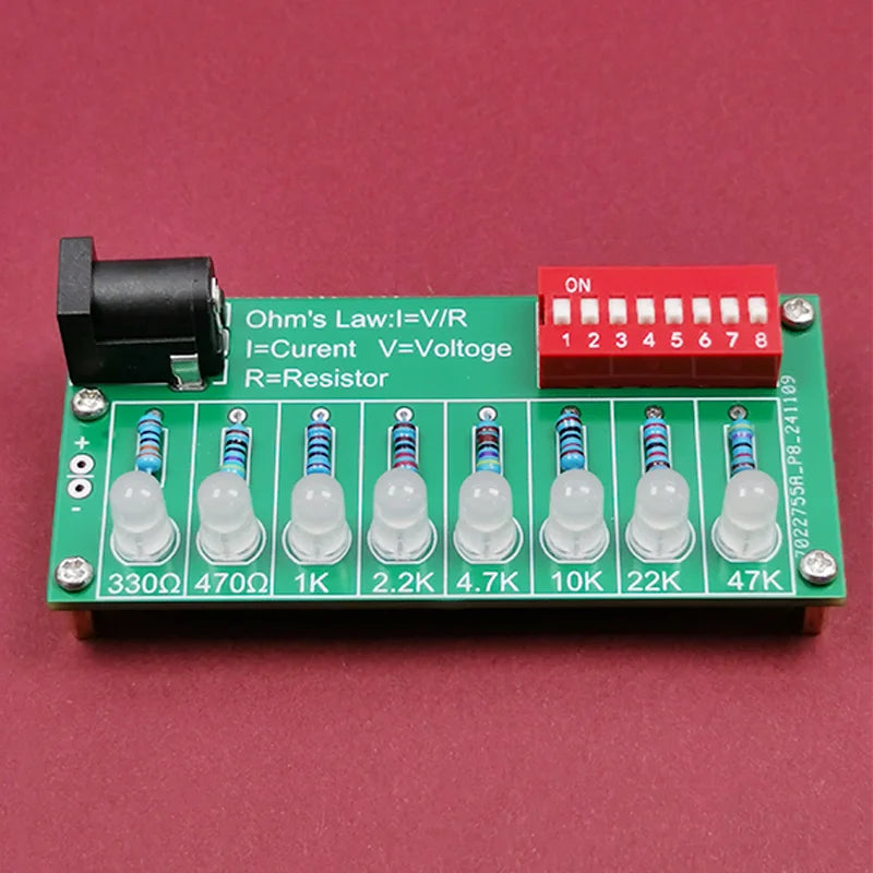 Assembled LED soldering practice board with component values and switch bank